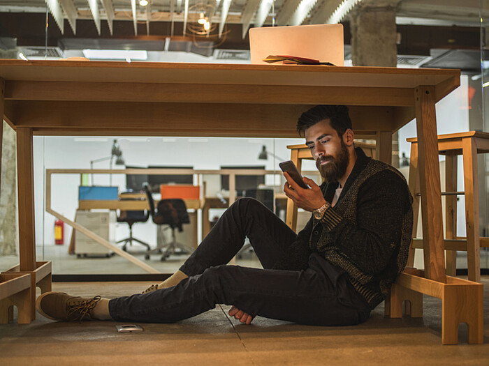 Un homme se protège sous une table